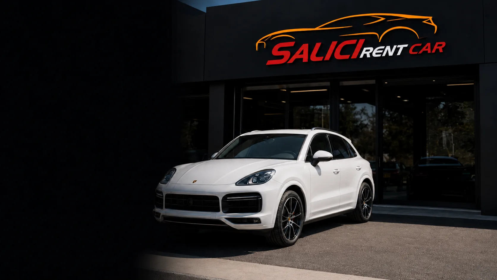 Porsche Cayenne bianca davanti alla sede Salici Rent Car a Catania, sotto l'insegna dell'autonoleggio